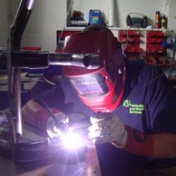 Man Welding in Workshop